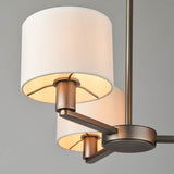 Endon Bexley 3 light pendant in antique bronze with three curved arms and marble-effect faux silk drum shades, shown close-up against a grey background.