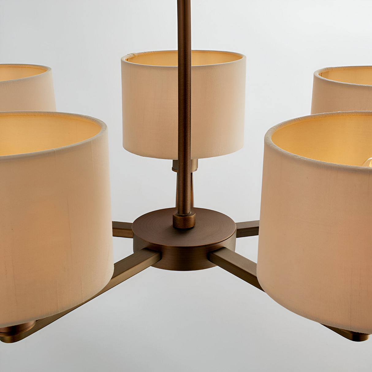 Close-up of the Endon Bexley 5 Light Pendant in bronze, showing the central plate, arms, and marble-effect faux silk drum shades on a white background.
