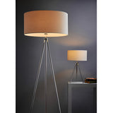 Cranwell Table Lamp with chrome tripod legs and cream fabric drum shade, shown on a console table alongside a matching floor lamp.