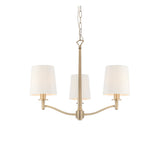 Endon Castwell 3-light pendant with vintage white fabric shades and matt antique brass metalwork on a chain suspension, shown on a white background.