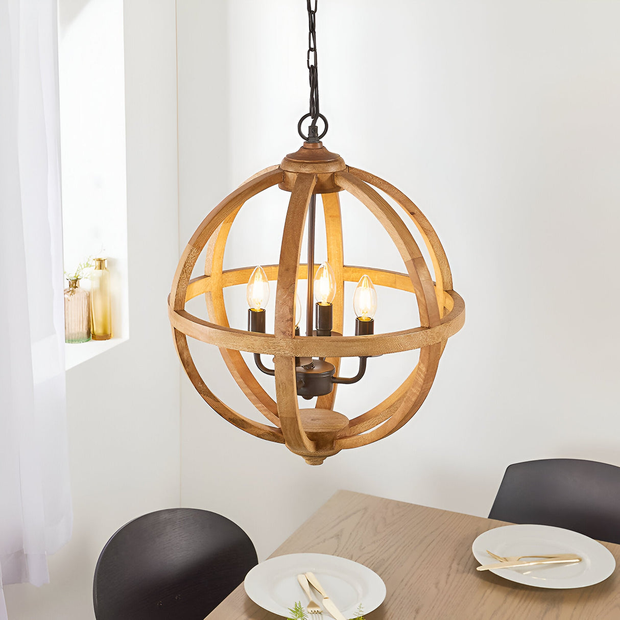 Cranleigh 4 Light Pendant with natural mango wood globe hoops and bronze fitting, four candle bulbs, hung above a dining table.