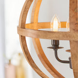 Close-up of the Cranleigh 4 Light Pendant's natural mango wood globe frame and dark bronze fitting with candle-style bulb, on a plain light background.