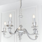 Endon Brambourne 5 light pendant in polished aluminium with curved arms and candle-style lamps, suspended from a chain against white panelled walls.