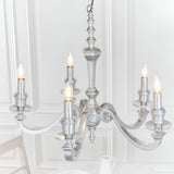 Endon Brambourne 5 light pendant in polished aluminium with curved arms and upward candle-style lamps, shown against a white panelled dining room wall.