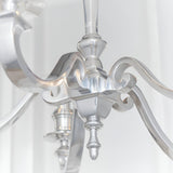 Close-up of the Endon Brambourne 5 Light Pendant in polished aluminium, showing the central column, scrolled arms and decorative finial.