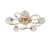 Endon Harcourt 5 light semi-flush ceiling light in antique brass, with looped arms and mesh-caged glass globe shades, shown on a white background.
