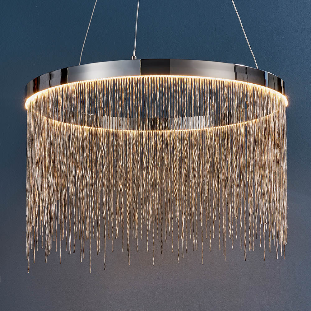 Danestead Pendant in polished chrome, a circular ring fixture with an integrated LED ring behind cascading fine chains, shown against a dark blue background.
