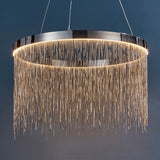 Danestead Pendant in polished chrome, a circular ring fixture with an integrated LED ring behind cascading fine chains, shown against a dark blue background.