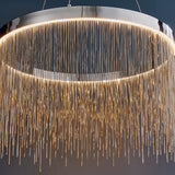 Danestead Pendant in polished chrome, showing a circular LED ring behind cascading fine chains that catch and reflect the light.