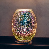 Endon Cliffwick touch table lamp illuminated on a dark shelf, showing its oval holographic glass body with a colourful firework burst effect on a chrome base.