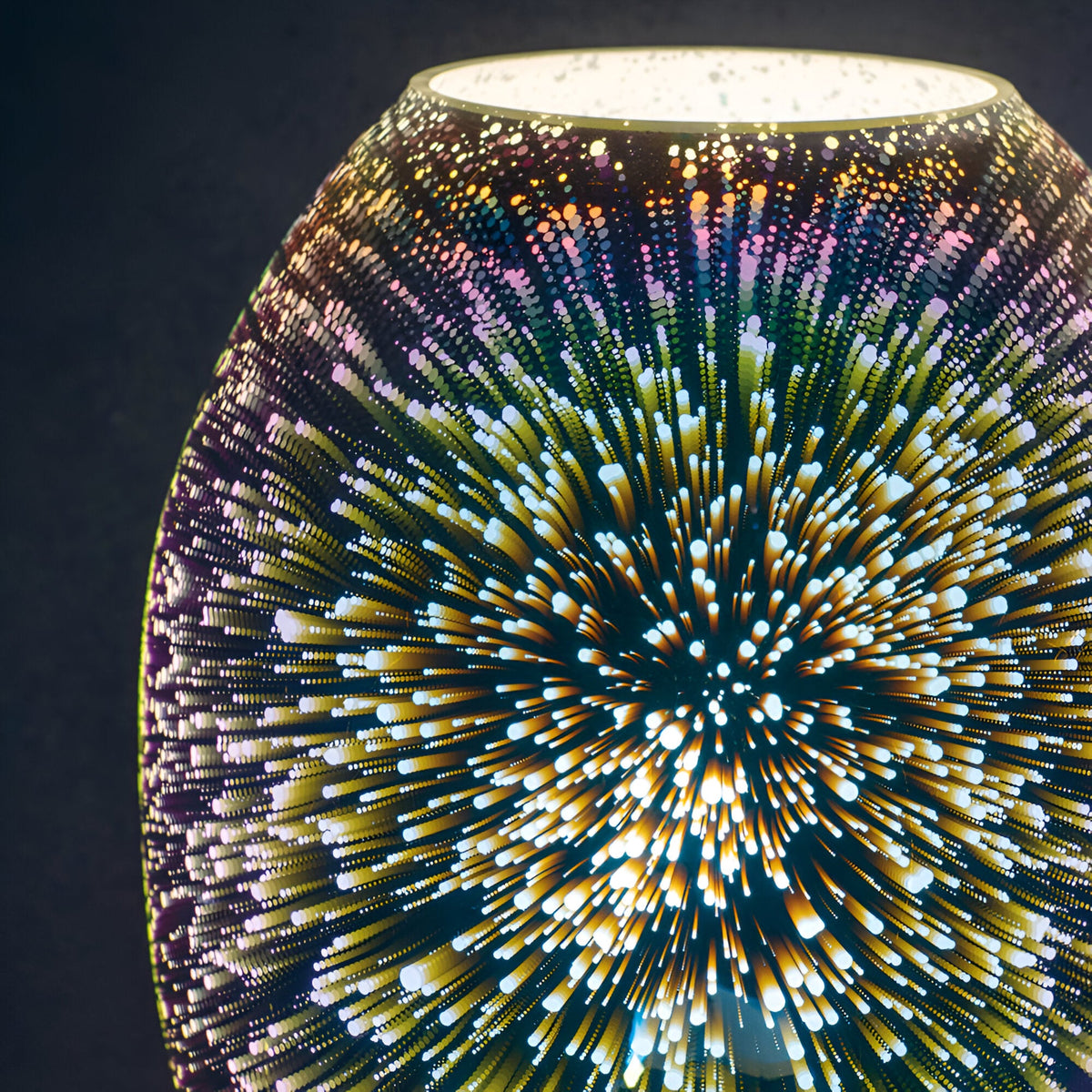 Close-up of the Endon Cliffwick touch table lamp showing its holographic glass body with a colourful starburst light effect against a dark background.