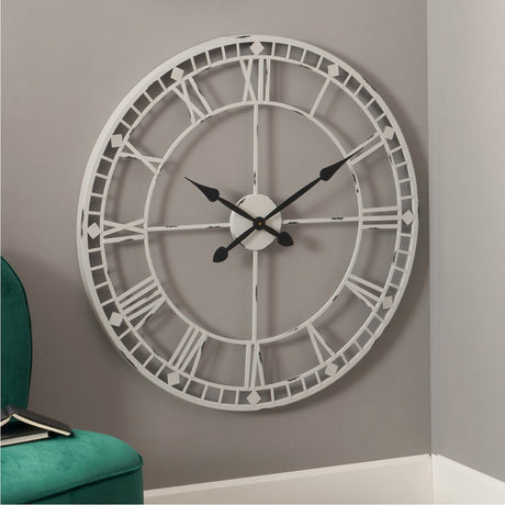 Antique grey iron round wall clock, 80cm, with skeleton Roman numeral dial and black hands, shown mounted on a living room wall.