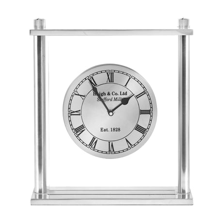 Silver metal and glass table clock, 28cm, with a rectangular open frame, round dial, Roman numerals, and black hands, set against a plain white background.