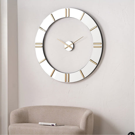 Mirrored & Gold 2 Piece Open Wall Clock, 120cm, with gold Roman numerals and hands, shown mounted above a beige armchair in a living room.
