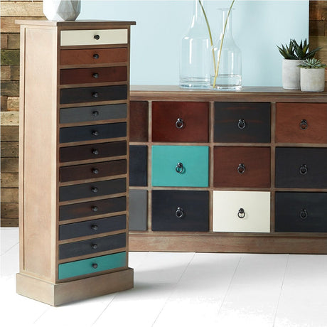 Loft Blue Multicoloured Pine 13 Drawer Unit, a tall narrow chest of drawers in mixed teal, cream, red and black tones, shown beside a matching sideboard in a room setting.
