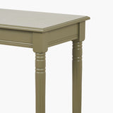 Close-up of the Heritage Olive Pine Console Table's turned wooden legs and apron, showing fluted detailing and a green painted finish against a plain white background.
