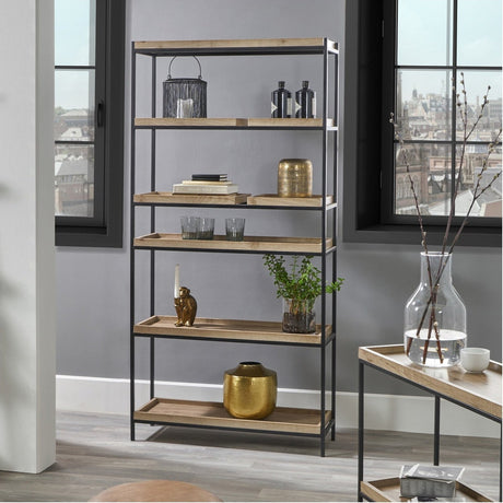 Gallery Wood Veneer & Black Iron 5 Shelf Shelving Unit, 184cm tall, styled with decor in a living room with grey walls and large windows.