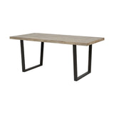 Marca dining table with sand wash acacia wood top and angled black iron legs, shown at an angle on a plain white background.