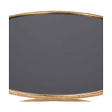 Close-up of the Veneziano coffee table's round black glass top with antique gold iron rim, showing the curved edge and part of the base.