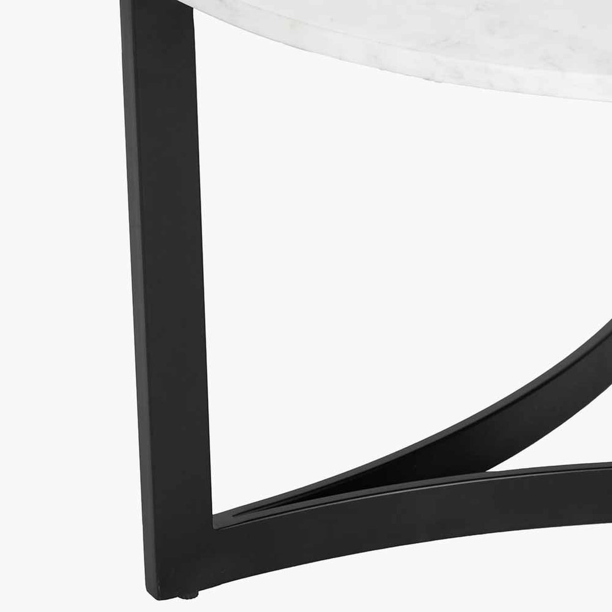 Close-up of the Hendrick coffee table's black iron leg and curved cross brace beneath a white marble tabletop, shown against a plain background.