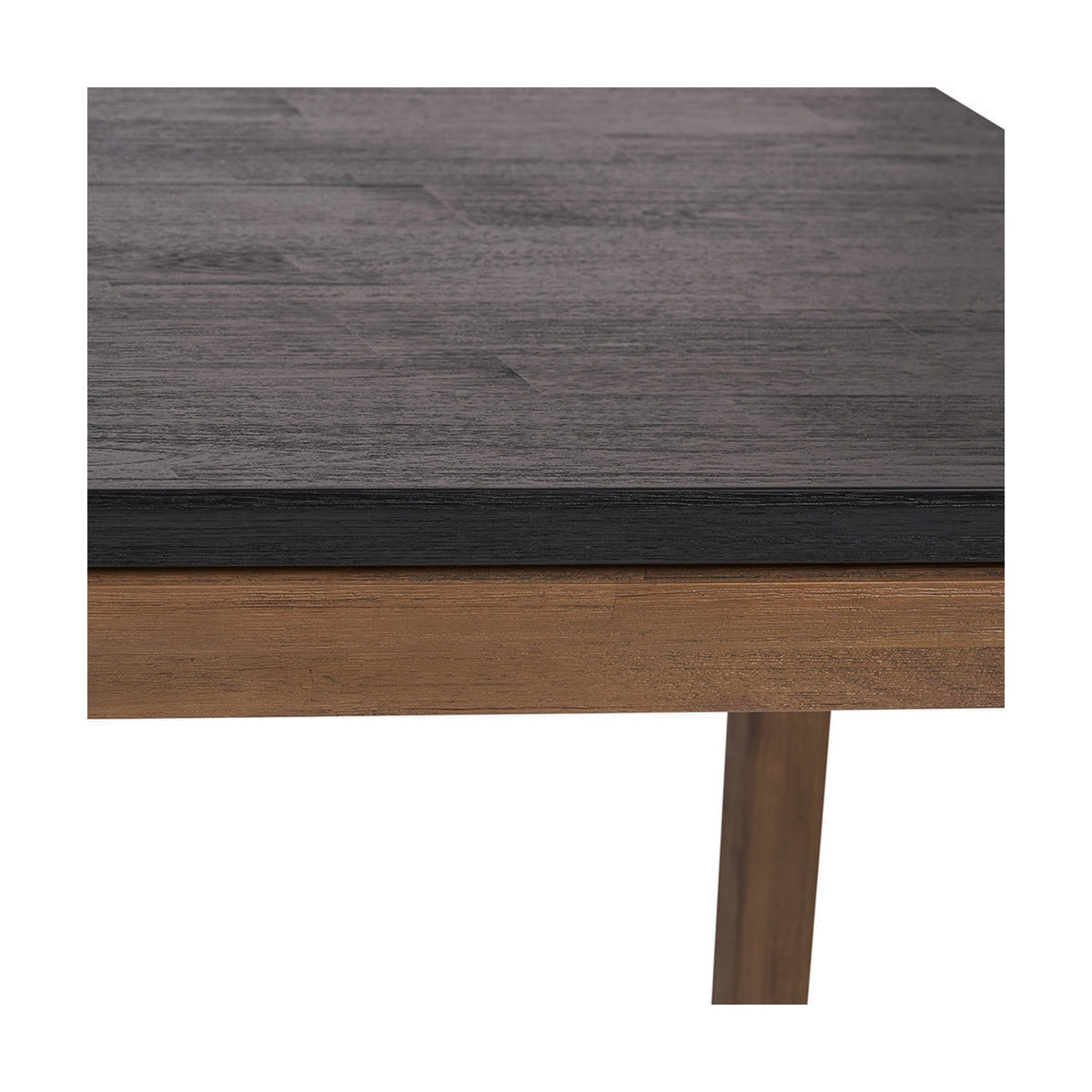 Close-up of the Gio Black & Acacia Dining Table showing a dark wood-grain tabletop edge above a natural acacia frame and tapered leg on a white background.