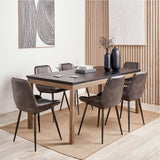 Gio Black & Acacia Dining Table with rectangular black top and wooden legs, set in a dining room with leather-look chairs, place settings, and black vases.