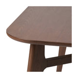 Close-up of the Elias Dark Ash Wood Retro Dining Table, showing the rounded tabletop edge, visible wood grain, and angled tapered leg joined by a horizontal stretcher.
