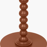Close-up of the Margot Terracotta Wood Bobble Side Table's turned wooden pedestal with stacked bobble detailing, in a matte terracotta finish against a plain white background.