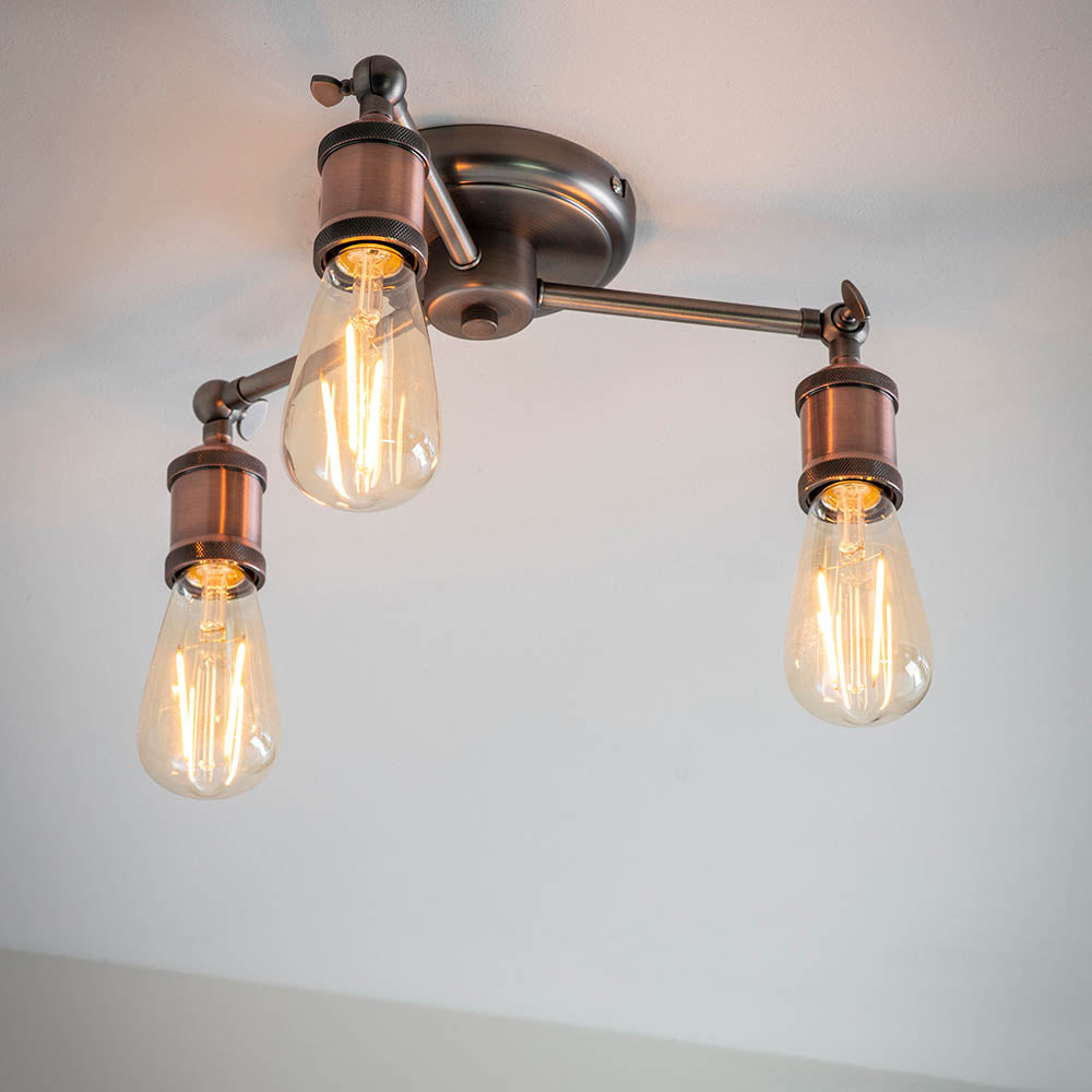 Brackley 3 Light Semi-Flush Ceiling Light in pewter and copper, three angled metal arms with exposed E27 bulbs against a plain white ceiling.