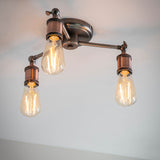 Brackley 3 Light Semi-Flush Ceiling Light in pewter and copper, three angled metal arms with exposed E27 bulbs against a plain white ceiling.