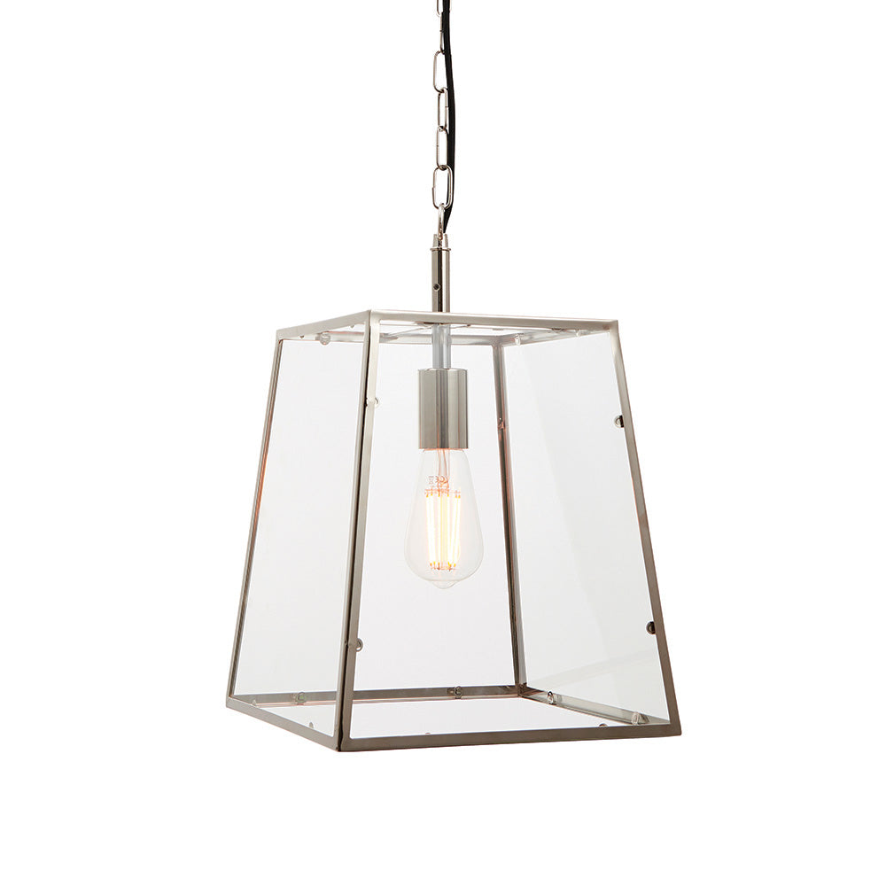 Brenton Lantern Pendant in nickel, tapered box-frame design with clear glass panels and exposed filament bulb, hung on a black chain against a white background.