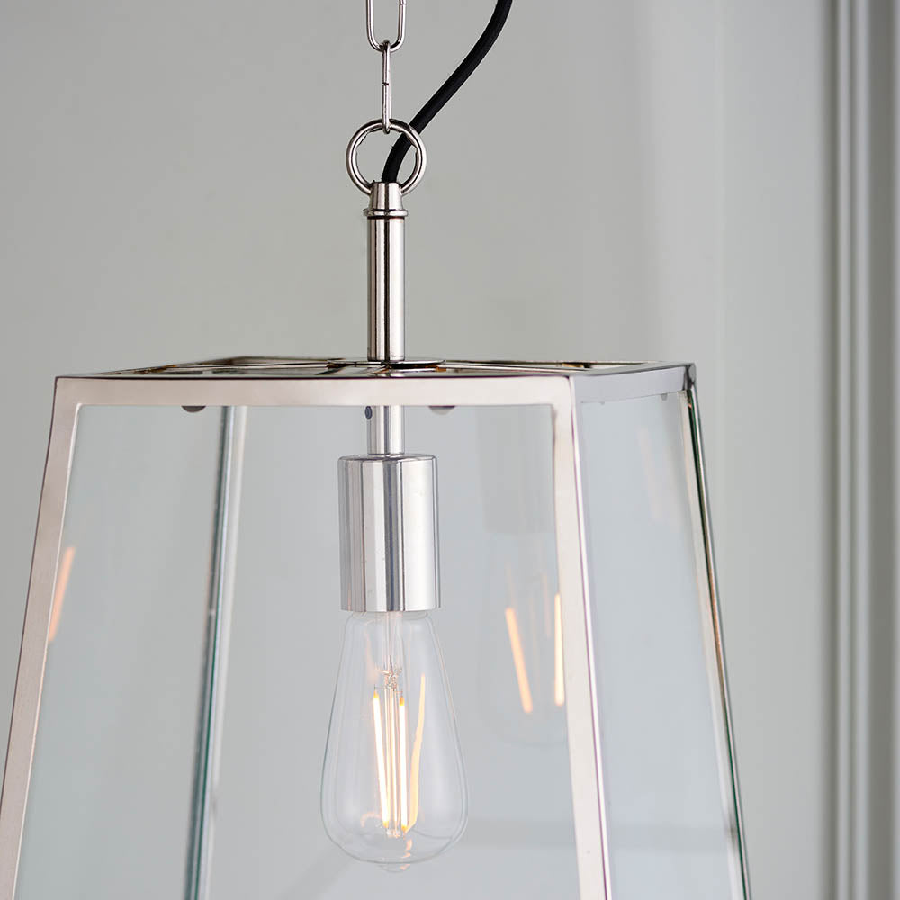 Brenton Lantern Pendant in nickel with tapered glass-panelled frame, black fabric flex, and exposed filament E27 bulb, shown close-up.