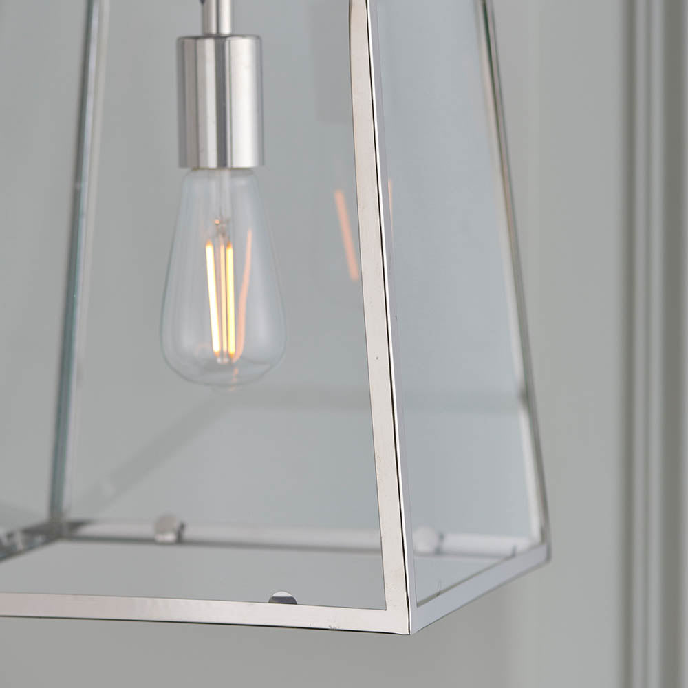Close-up of the Brenton Lantern Pendant in nickel, a tapered box-frame light with clear glass panels and an exposed E27 filament bulb.
