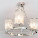 Endon Winslow 3 light semi-flush ceiling light in nickel with textured glass cylinder shades on a circular ring frame, shown illuminated.