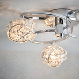 Endon Seraphine 3 light semi-flush ceiling light in polished chrome with faceted crystal globe shades, shown illuminated close to the ceiling.