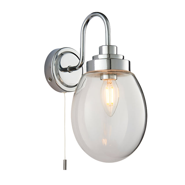 Endon Bramworth bathroom wall light in chrome with curved arm, clear glass globe shade, E14 bulb, and pull cord switch on a white background.