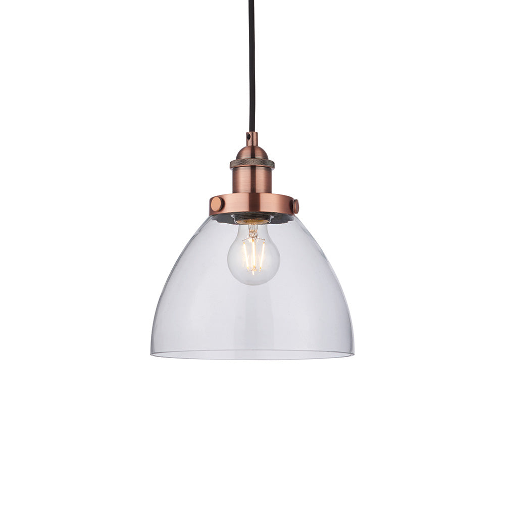 Endon Wentworth industrial pendant light with a clear glass dome shade, copper knurled lamp holder, exposed E27 filament bulb and black flex, on white.