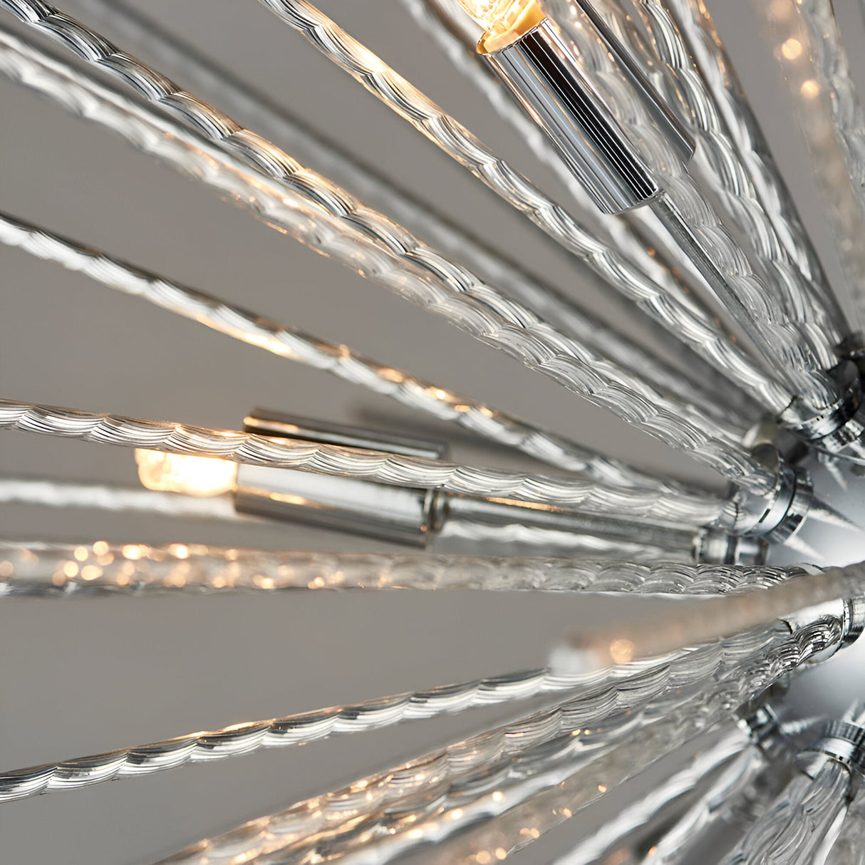 Close-up of Endon Caldleigh 9 light pendant showing textured polished chrome rods radiating from the centre with G9 lamps at the tips.