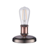 Endon Brackley small industrial table lamp in aged pewter and copper with knurled E27 holder and exposed filament bulb on a plain white background.