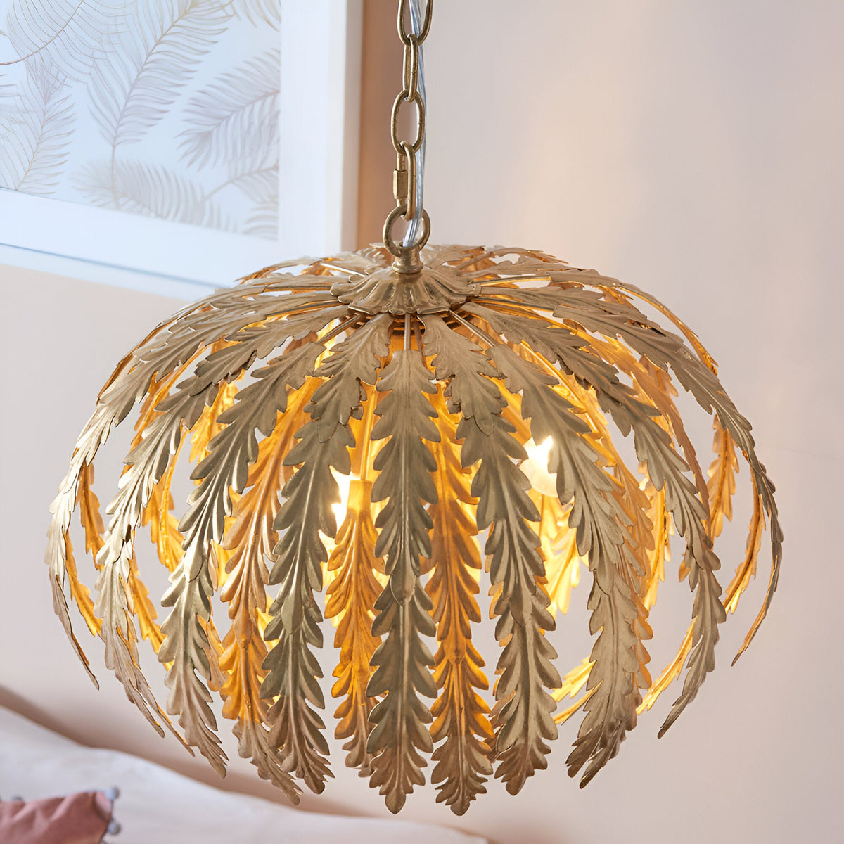 Endon Colette 3 light pendant in gold leaf with layered floral leaf shades, illuminated and suspended by chain in a softly lit interior.