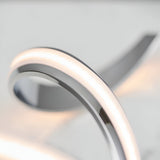 Close-up of the Endon Neve table lamp showing its polished chrome curves and illuminated white diffuser band.