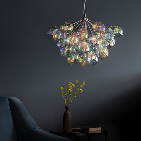 Endon Brenworth 6 light pendant with clustered iridescent glass globes on a chrome frame, hanging in a dark blue room above a vase of yellow flowers.
