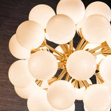 Close-up of the Fitzroy 28 Light Pendant showing clustered gloss white opal glass globes on a brushed brass sunburst frame.