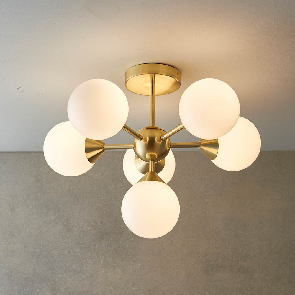 Fitzroy 6 Light Semi-Flush Ceiling Light in gold brass with six opal glass globes on splayed arms, mounted on a round ceiling plate.