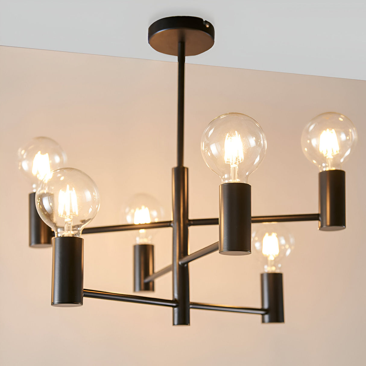 Endon Marlowe 6 Light semi-flush ceiling light in matt black metal, six arms with exposed globe bulbs radiating from a central rod.