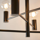 Close-up of Endon Marlowe semi-flush ceiling light showing matt black metal arms, cylindrical lamp holders and exposed E27 bulbs against a pale wall.