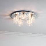 Endon Marguerite 5 light flush ceiling light in chrome with clear glass and crystal cylindrical shades, shown illuminated against a white ceiling.