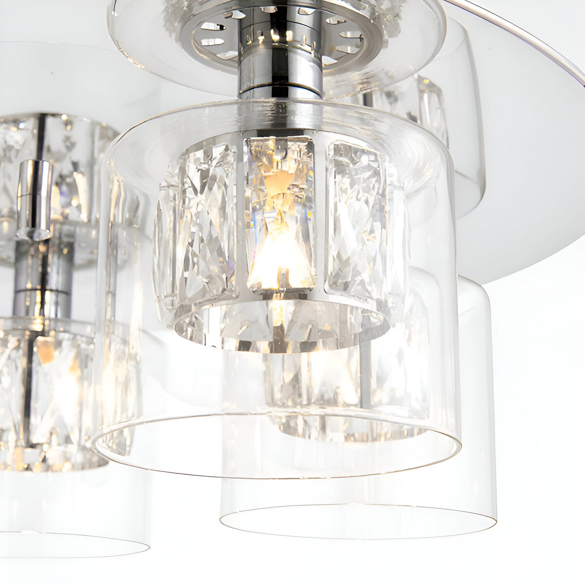 Close-up of Endon Marguerite 5 light crystal flush ceiling light in chrome, showing glass shades with faceted crystal inserts around lit G9 lamps.
