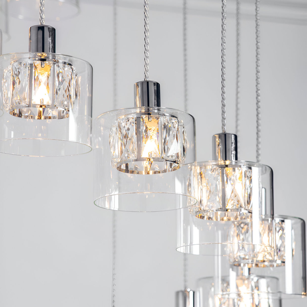 Marguerite 12-light pendant in polished chrome with faceted crystal shades in clear glass diffusers on adjustable cables.
