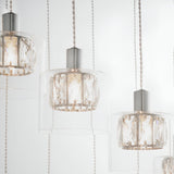 Marguerite 12 Light Pendant in polished chrome, close-up of crystal drum shades in clear glass diffusers on adjustable cables against a white background.